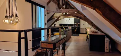 Coin salon dans l'établissement Apparthotel loft Martigné-Ferchaud