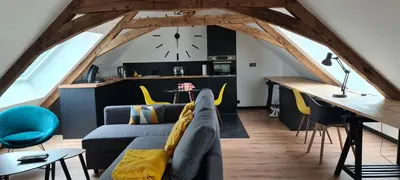 Coin salon dans l'établissement Apparthotel loft Martigné-Ferchaud