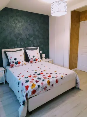Un ou plusieurs lits dans un hébergement de l'établissement chambre d'hôtes Les Hortensias