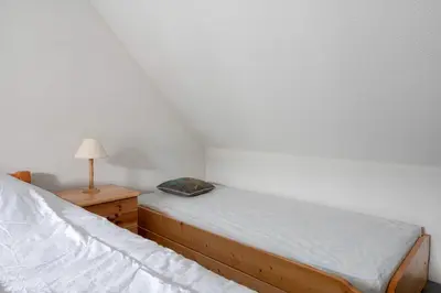 Un ou plusieurs lits dans un hébergement de l'établissement Vacances familiales dans cette maison à Pornichet