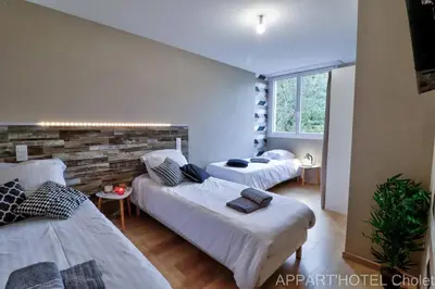Un ou plusieurs lits dans un hébergement de l'établissement Appart' hôtel Cholet