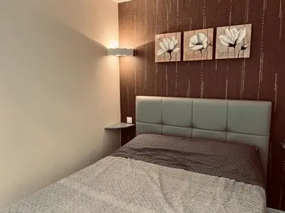 Un ou plusieurs lits dans un hébergement de l'établissement Standing et océan à 50m, appartement de l'oasis