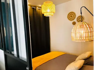 Un ou plusieurs lits dans un hébergement de l'établissement Joli studio cosy