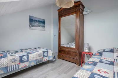 Un ou plusieurs lits dans un hébergement de l'établissement Face à la mer, appartement sous les toits pour 4