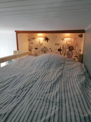 Un ou plusieurs lits dans un hébergement de l'établissement Maison de vacances vue mer