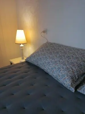 Un ou plusieurs lits dans un hébergement de l'établissement Maison de vacances vue mer