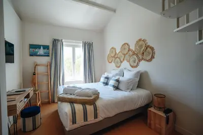 Un ou plusieurs lits dans un hébergement de l'établissement Hôtel Le Noirmoutier