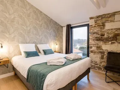 Un ou plusieurs lits dans un hébergement de l'établissement Ancienne grange rénovée près de Nantes avec spa et jardin - FR-1-306-1233