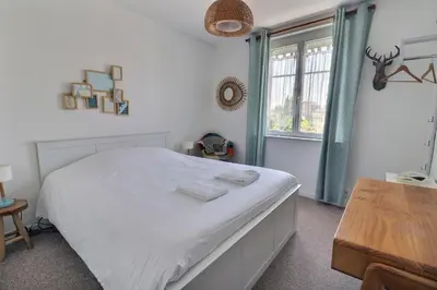 Un ou plusieurs lits dans un hébergement de l'établissement Hôtel Le Smile