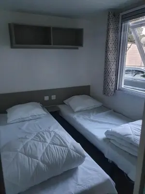 Un ou plusieurs lits dans un hébergement de l'établissement Camping 4 étoiles Le bois dormant